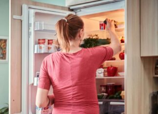 Žena uzima nešto iz frižidera